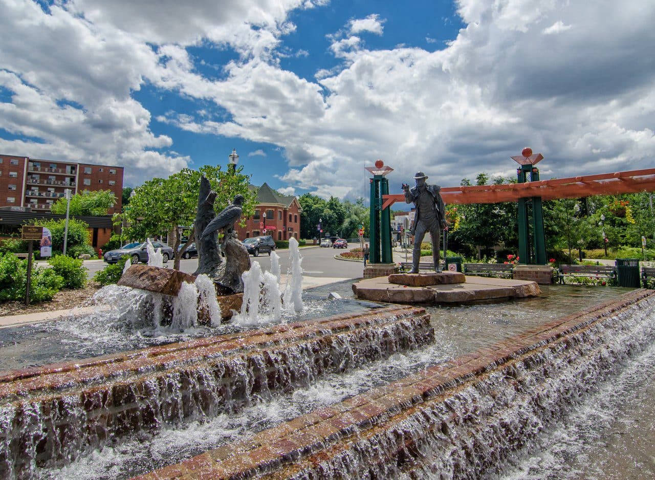 Neighborhood street with homes and driveways.