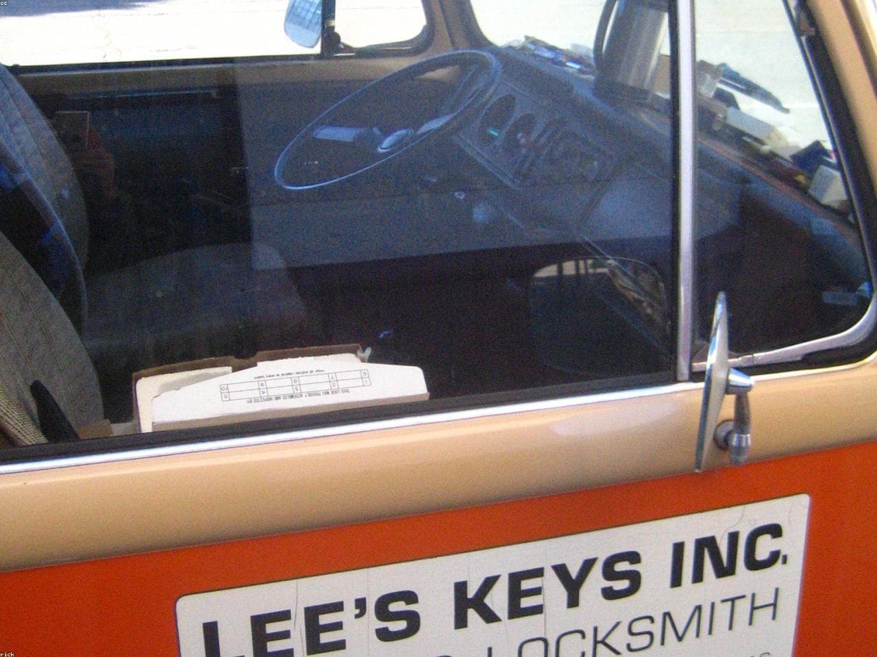 Technician assisting with a car door lockout.